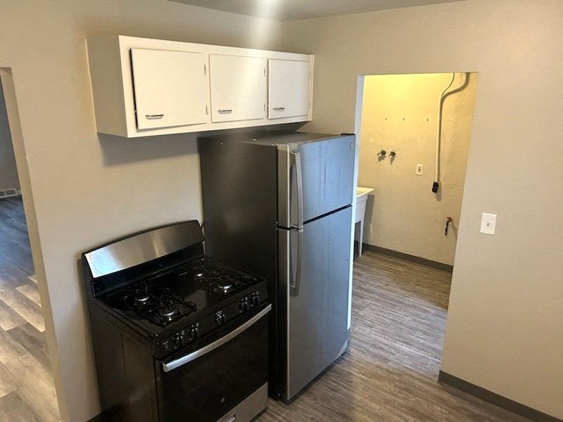 a kitchen with a stove and a refrigerator